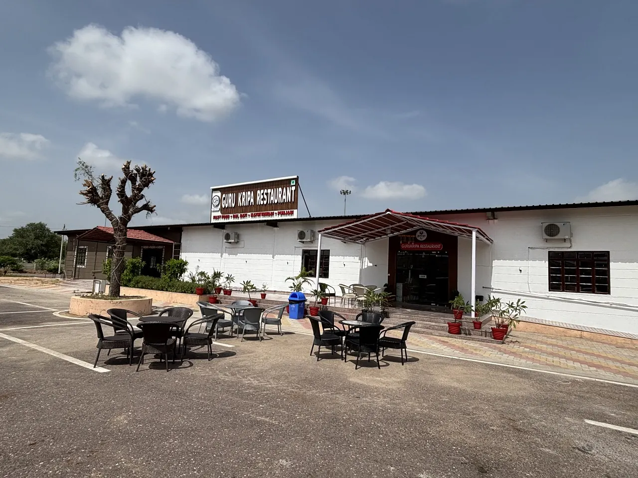 Outdoor tables in front of Guru Kripa restaurant on the Bharatmala Expressway