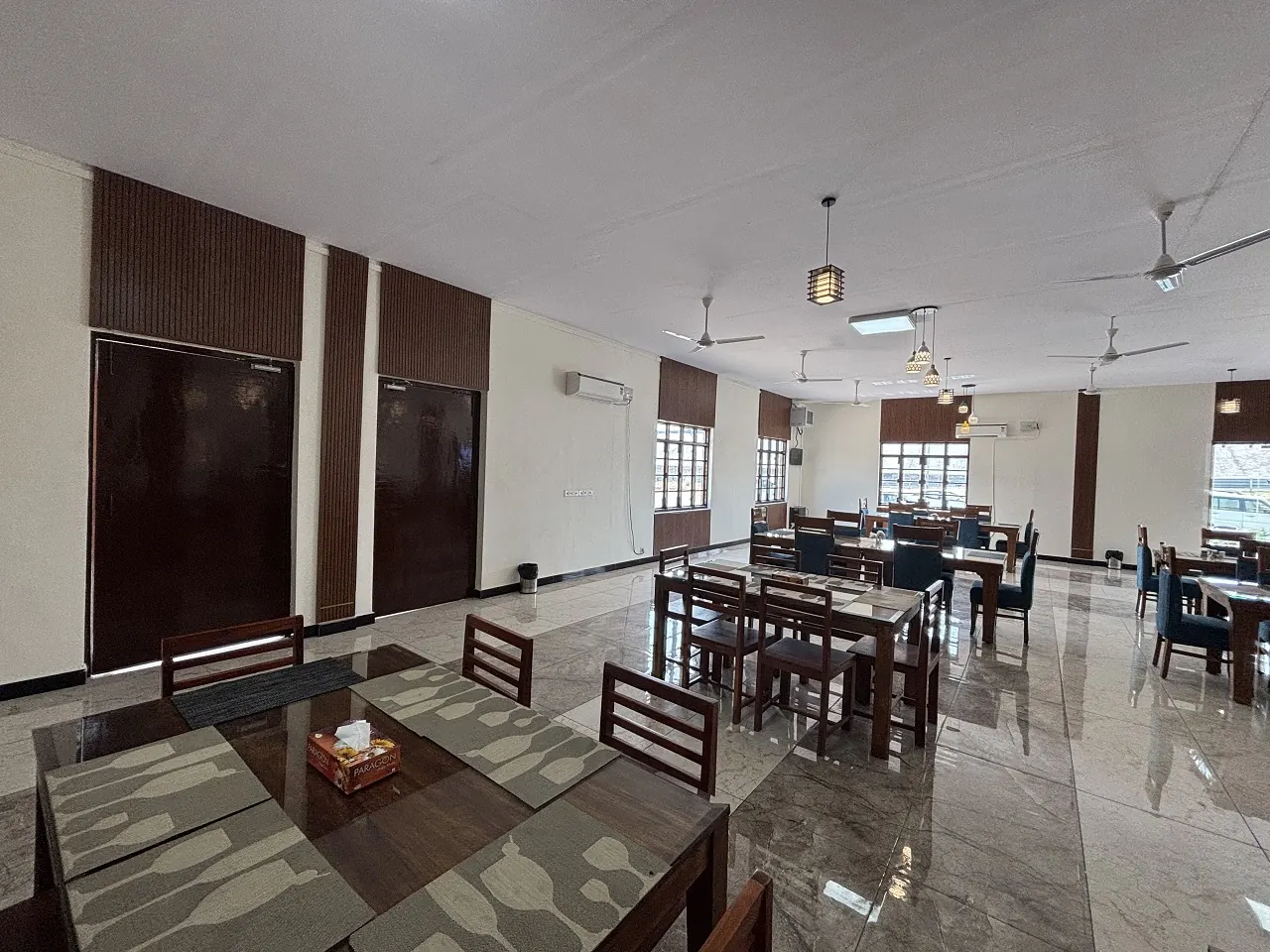 Family tables in the Guru Kripa dining hall, Agolai