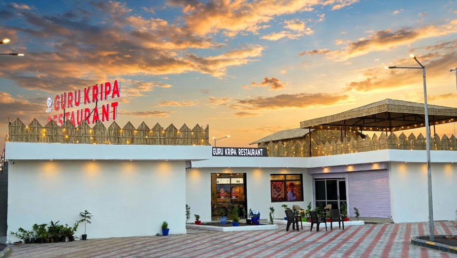 Guru Kripa Restaurant, Pachpadra, at sunset with its lit rooftop, near HPCL Refinery Gate No. 5