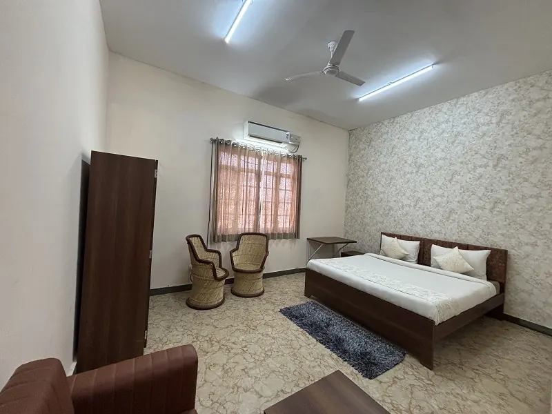 AC hotel room with a double bed at Guru Kripa, Agolai, on the Bharatmala Expressway
