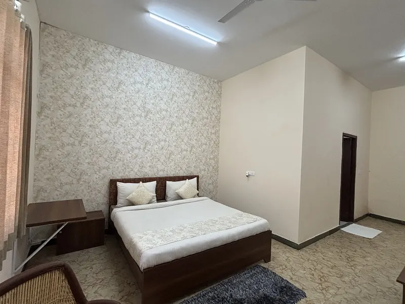 Hotel room with a double bed and wardrobe at Guru Kripa, Agolai